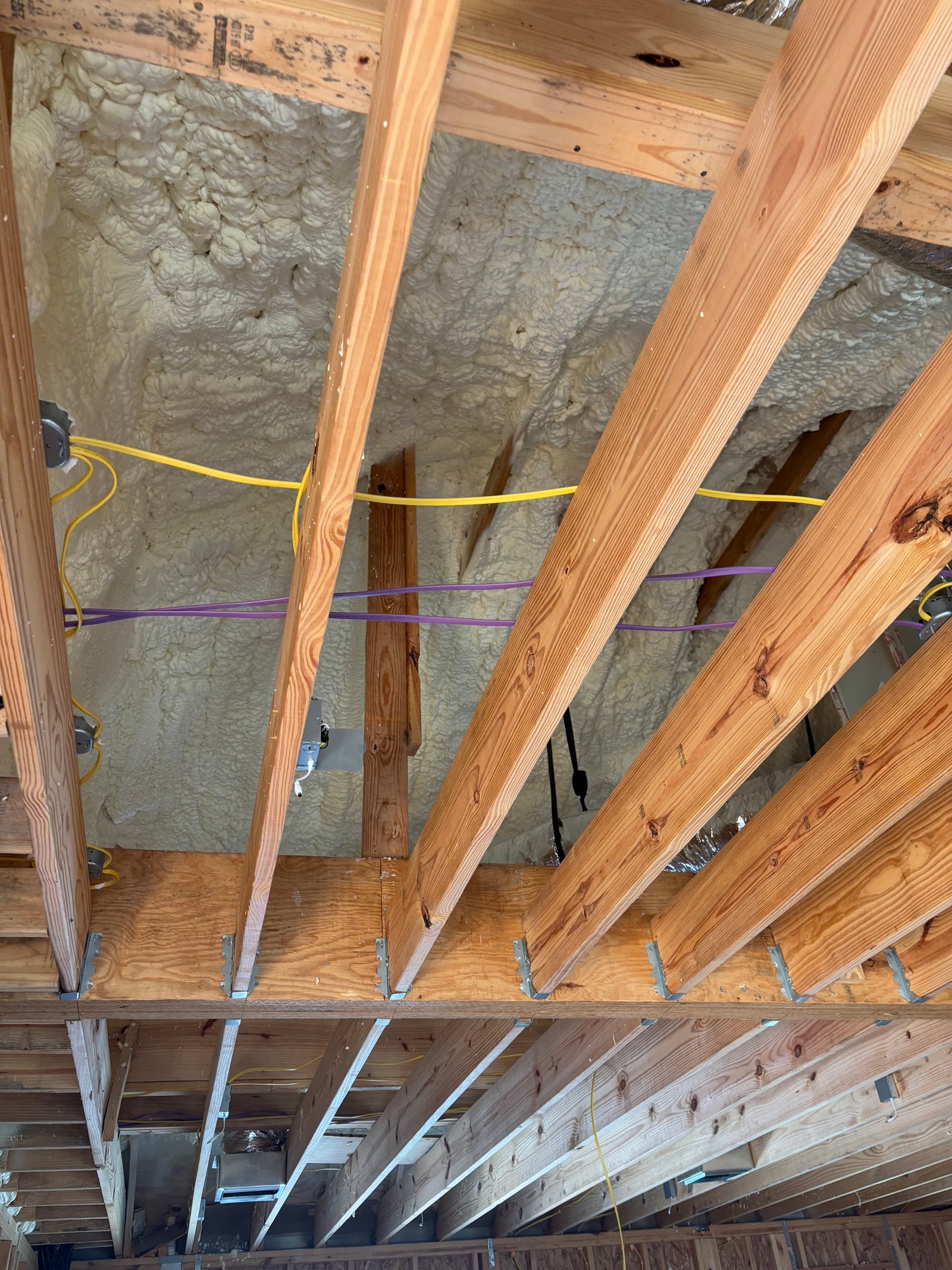 Spray foam insulation applied between rafters South Louisiana attic