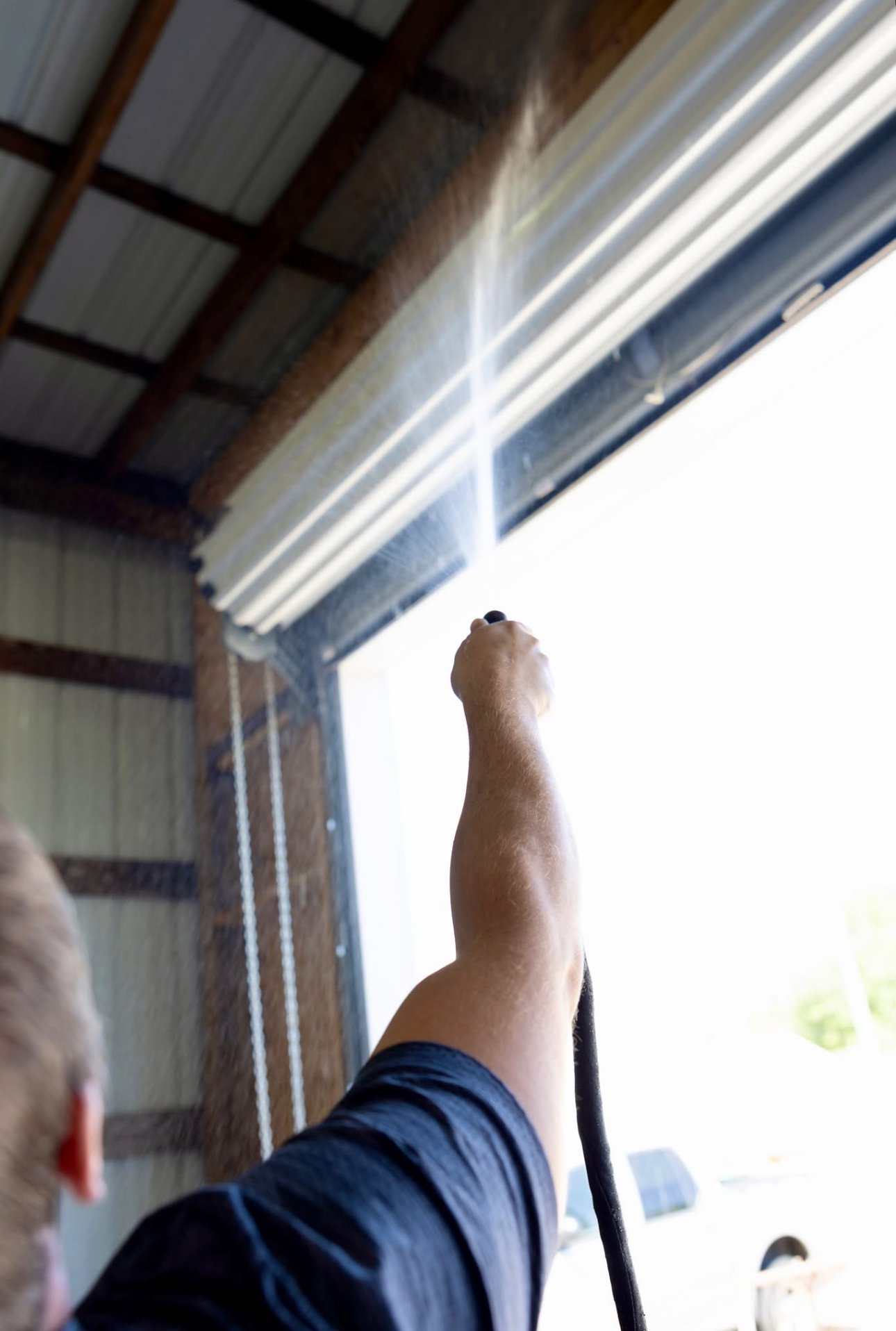 Spray foam being applied to metal building roof