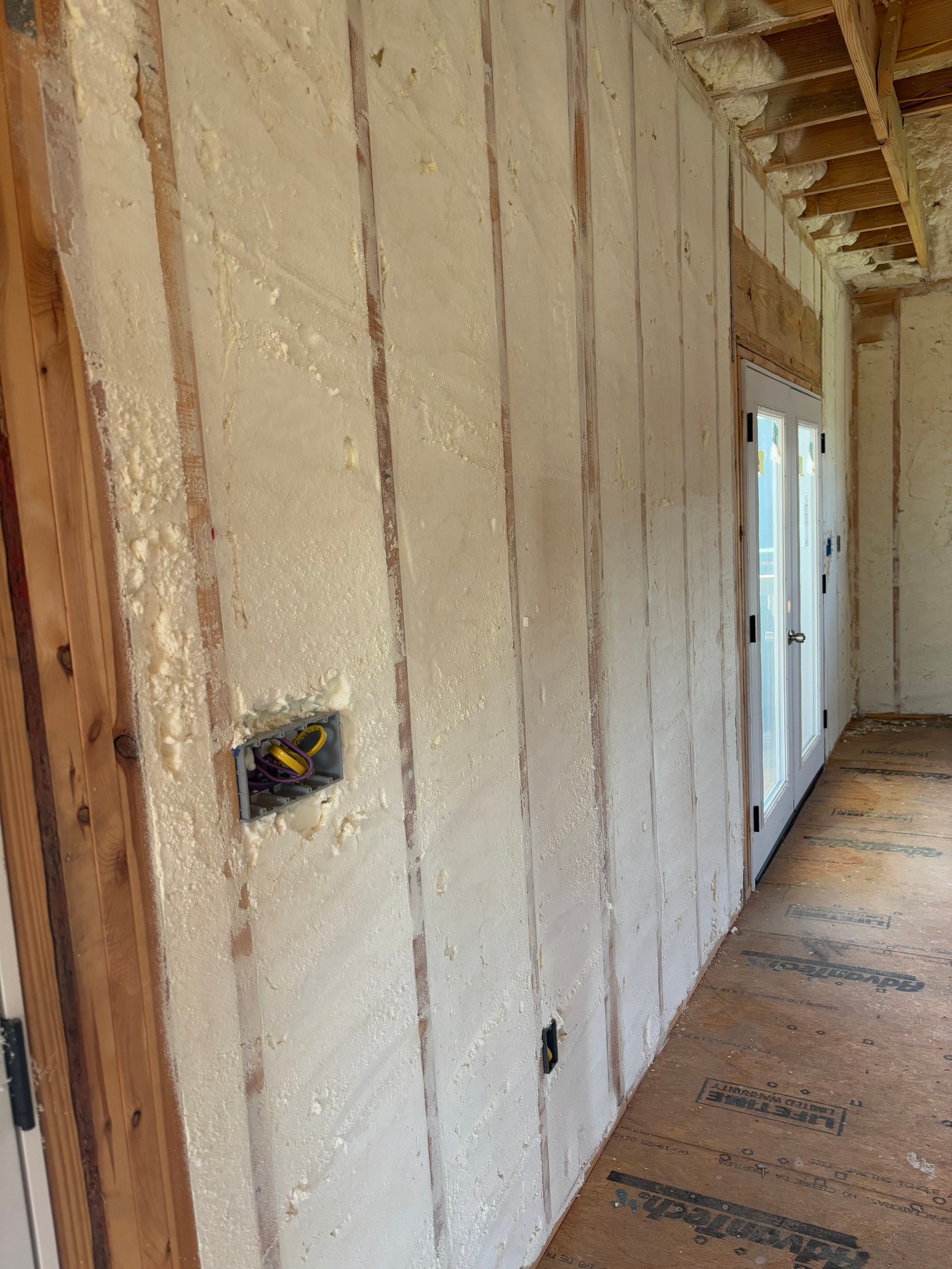 Spray foam on walls hallway new construction