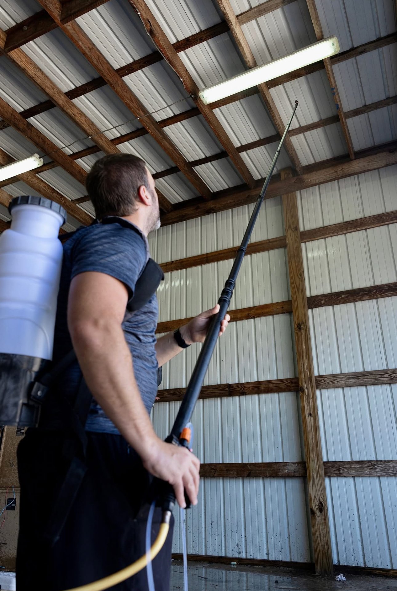 Bayou Spray Foam technician spraying metal building ceiling
